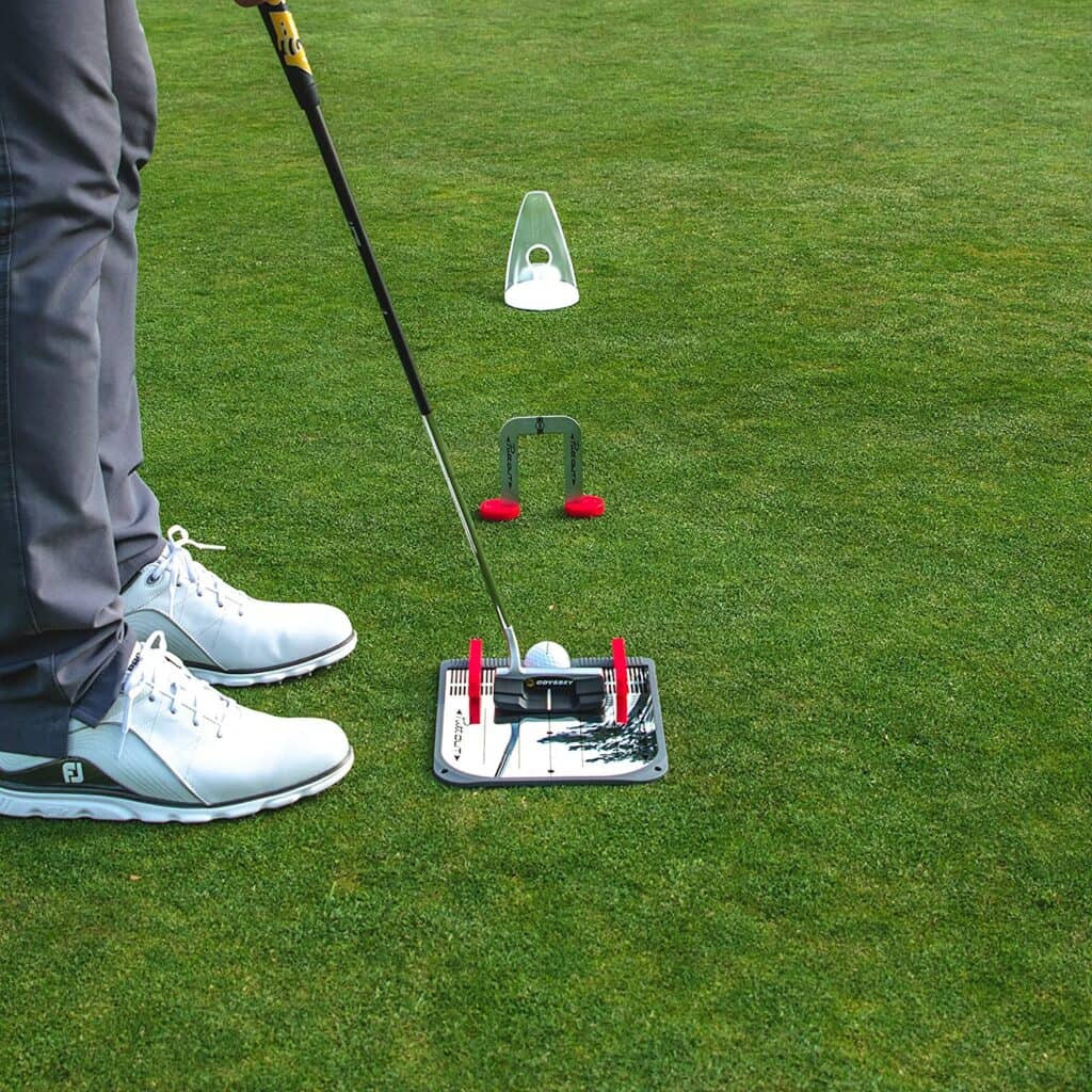 PuttOut Putting Mirror Trainer and Alignment Gate.  Golfer using the PuttOut Putting Mirror Trainer and Alignment Gate with his putter.  