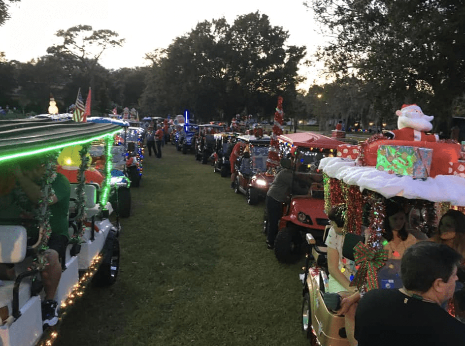 Photo by Joe Frietas shows long golf cart Christmas Parade, golf cart Christmas lights. https://www.facebook.com/wgchristmasgolfcartparade 