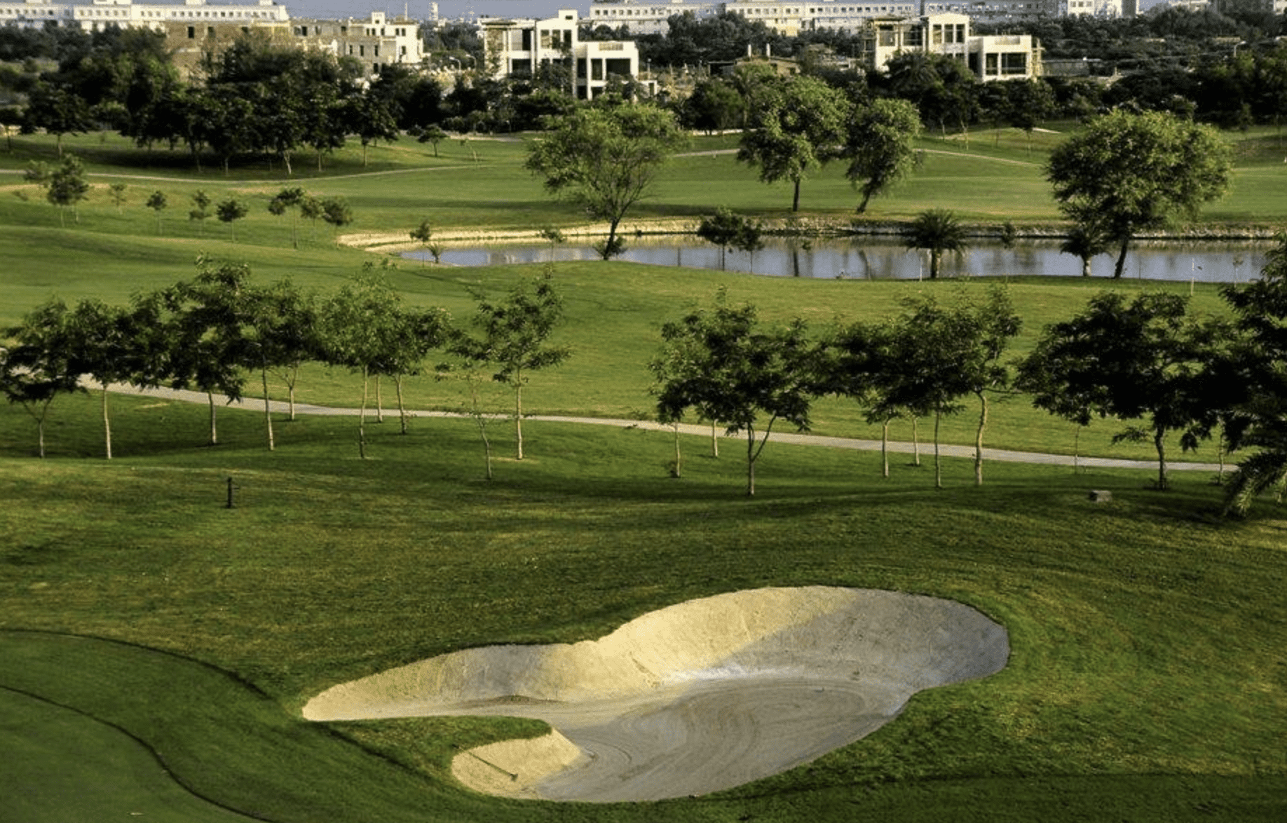 best golf courses in New Delhi India - Jaypee Gardens has gorgeous views with manicured sand traps and highrise buildings surrounding holes.