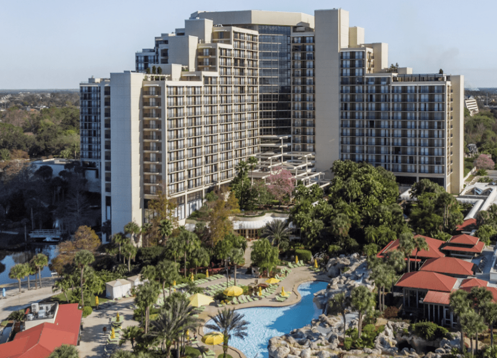 Hyatt Regency Cypress Resort in Orlando.  Exterior photo of the lake, hotel, and pools.  It is truly an ultimate retirement gift for golfers. 