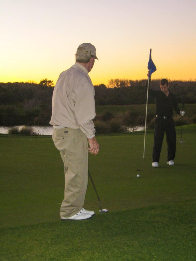 Photo of Dad golfing and putting on the green. Why is golf so fun?  You get to connect with friends and family.