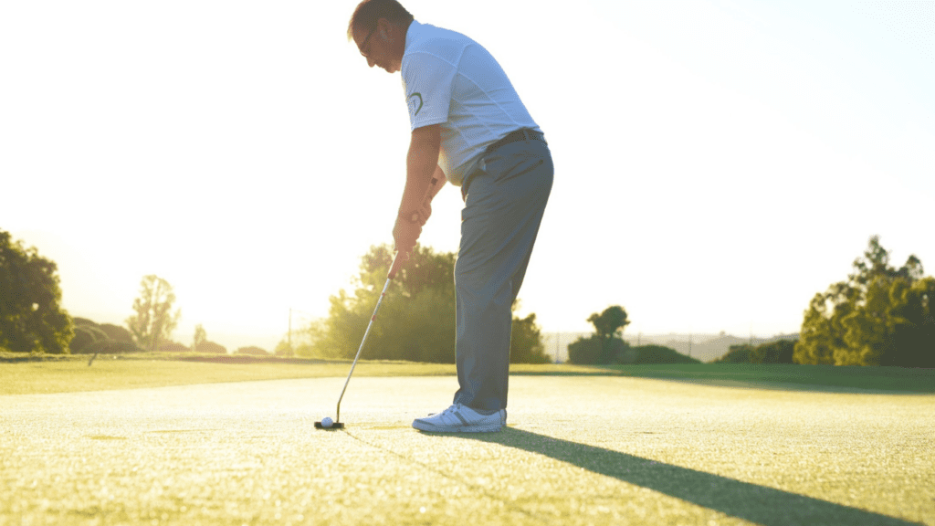 article on the best putter for bad putters, showing senior golfer getting ready to putt.