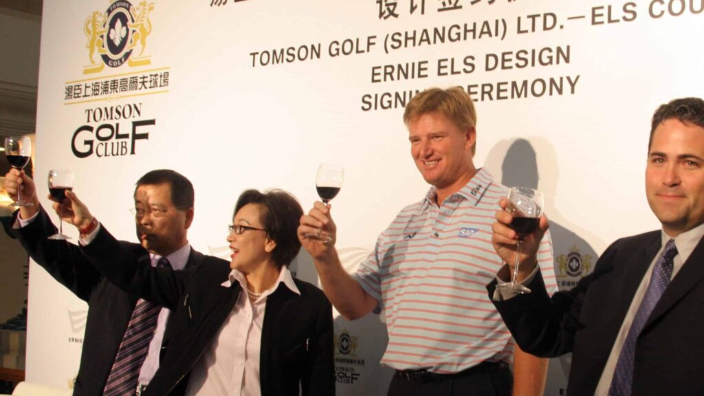 ernie els toasting with glass of red wine at Tomson Golf Club