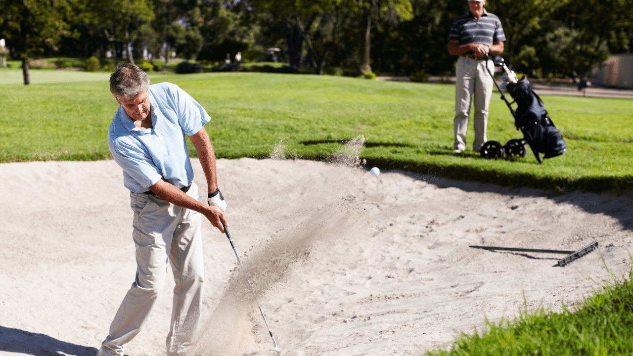 pitch shot photo of senior golfer in the sand trap