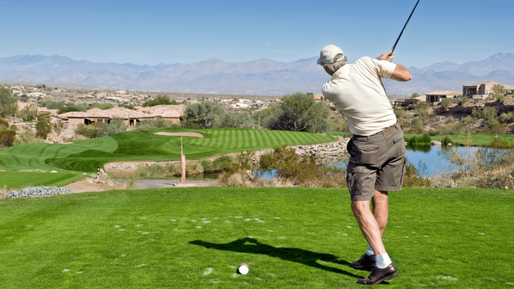 senior golfer hitting from tee box at a beautiful southwest golf course