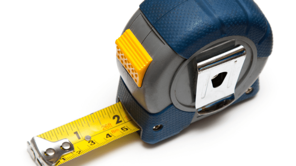 Tape measure showing inches with blue colored tape measure.  Photo by Canva Pro.
