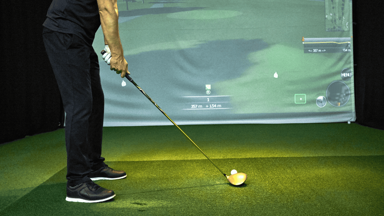 Golf Simulator under 10000 - photo of man hitting into the screen
