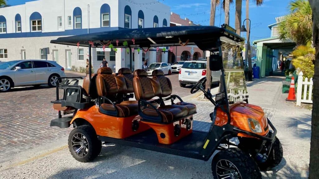 golf cart communities in Florida downtown showing a orange 6-seater golf cart